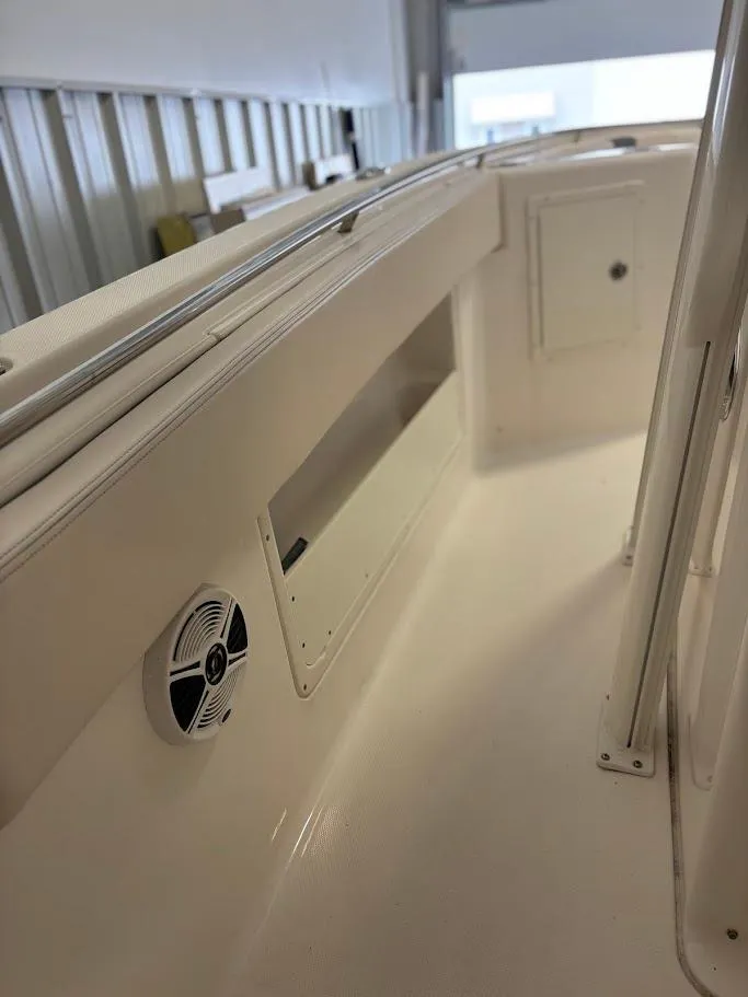 Slide: The Image of 2017 Robalo R302 Center Console interior with storage and speaker detail. - 11