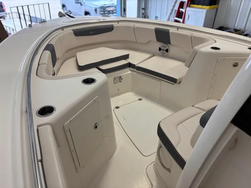 Slide: The Image of 2017 Robalo R302 Center Console boat interior with seating and storage compartments. - 12