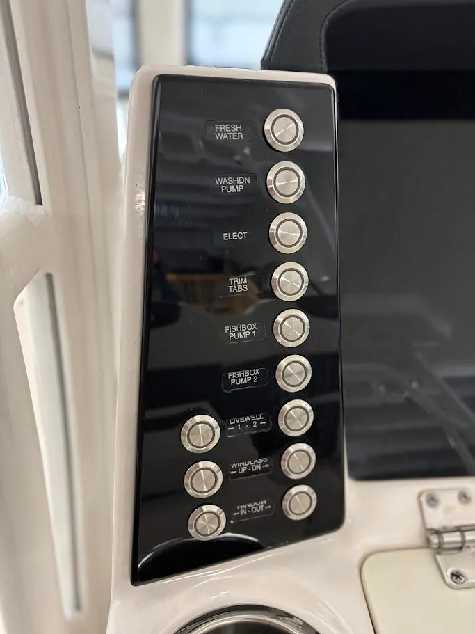Slide: The Image of Control panel of 2017 Robalo R302 Center Console boat with labeled buttons. - 13