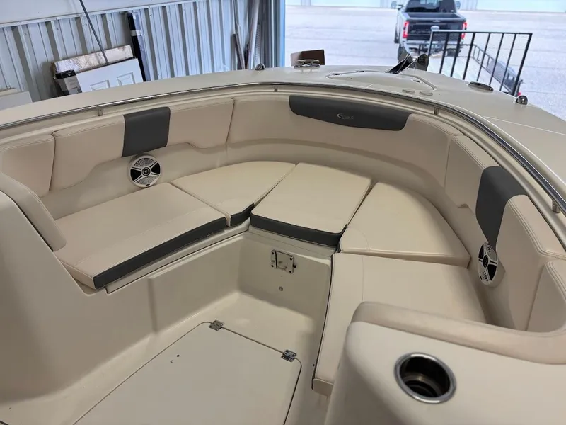 Slide: The Image of 2017 Robalo R302 Center Console boat interior with cushioned seating and speakers. - 15