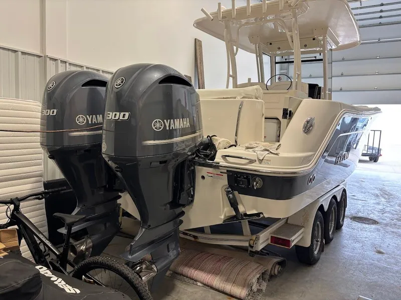 Slide: The Image of 2017 Robalo R302 Center Console boat with dual Yamaha 300 engines in a storage facility. - 36