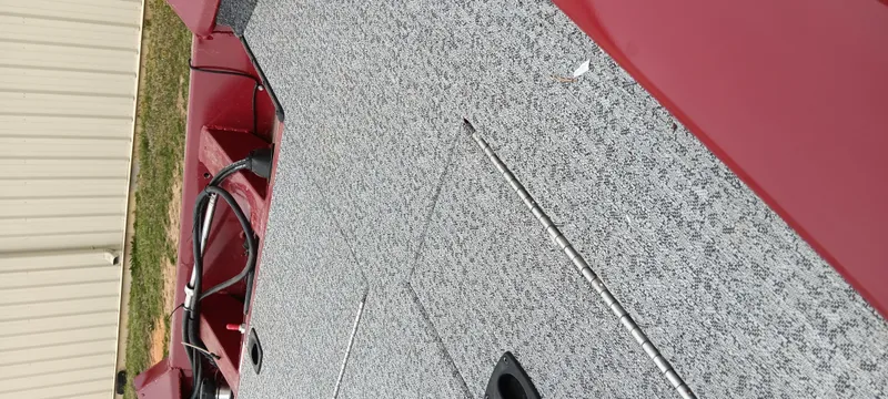 Slide: The Image of 2022 Tracker Pro Team 175 TXW boat deck with red accents and textured surface. - 10