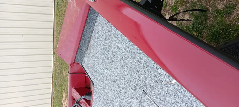 Slide: The Image of 2022 Tracker Pro Team 175 TXW boat, red exterior, gray interior, parked outdoors. - 11