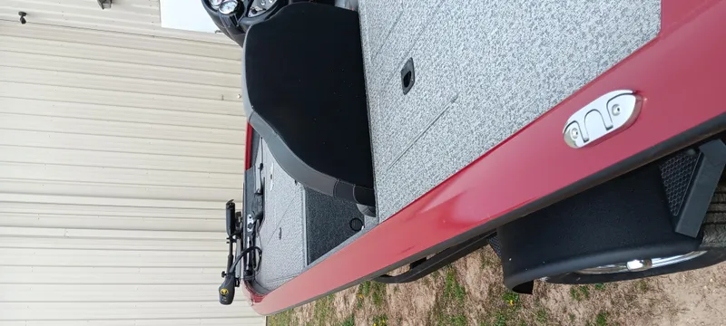 Slide: The Image of 2022 Tracker Pro Team 175 TXW boat, red exterior, parked outdoors. - 14