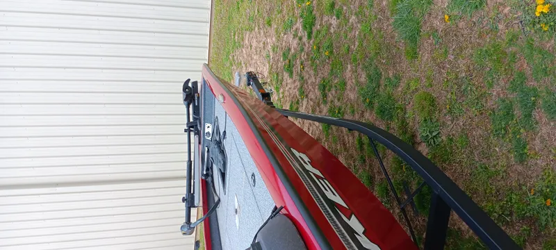 Slide: The Image of 2022 Tracker Pro Team 175 TXW boat parked on grass beside a white building. - 17