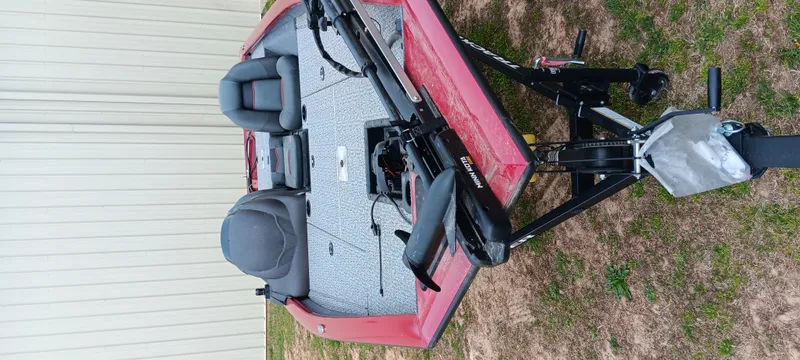 Slide: The Image of 2022 Tracker Pro Team 175 TXW boat on trailer, red exterior, gray interior, parked on grass. - 18