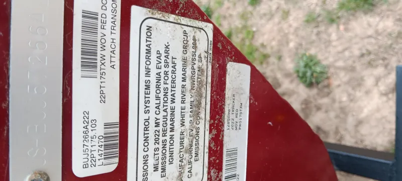 Slide: The Image of 2022 Tracker Pro Team 175 TXW emissions control information label on red surface. - 23