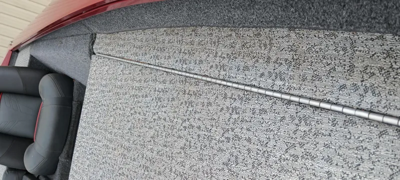 Slide: The Image of 2022 Tracker Pro Team 175 TXW boat interior with gray carpet and seating. - 7