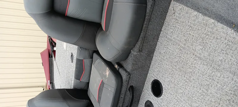 Slide: The Image of 2022 Tracker Pro Team 175 TXW boat interior with gray and red seats. - 9