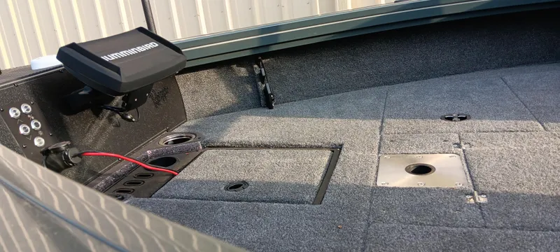 Slide: The Image of 2025 Ranger VX1788 WT boat interior with carpeted deck and electronic equipment. - 13