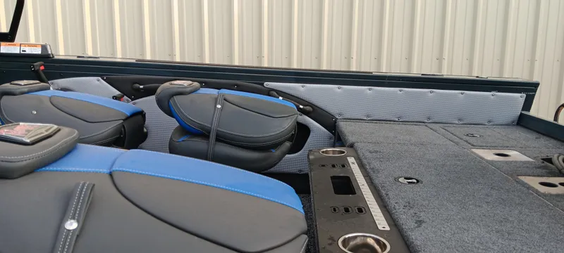 Slide: The Image of 2025 Ranger VX1788 WT boat interior with blue and black seats, spacious deck, and storage compartments. - 15