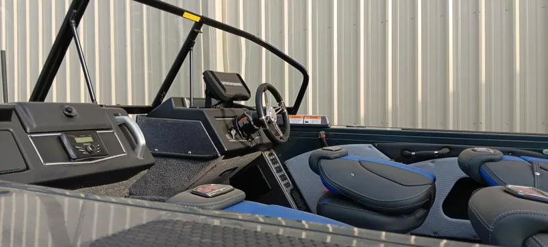 Slide: The Image of 2025 Ranger VX1788 WT boat interior with steering wheel and seating, against a corrugated metal background. - 18