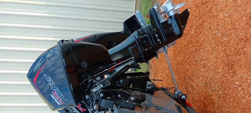 Slide: The Image of 2025 Ranger VX1788 WT boat engine, black and sleek, on a gravel surface. - 19