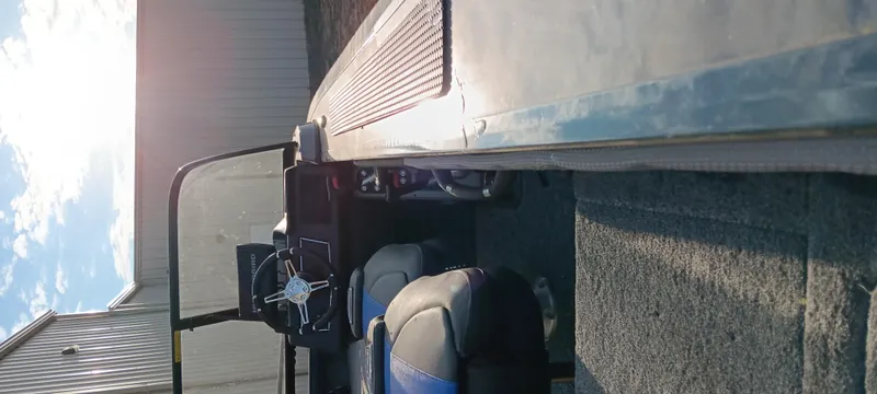 Slide: The Image of 2025 Ranger VX1788 WT boat interior with seats and steering, parked outdoors. - 5