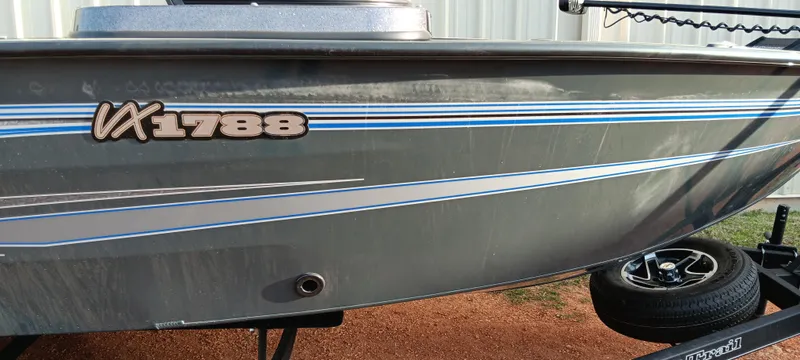 Slide: The Image of 2025 Ranger VX1788 WT boat with blue and white stripes on the side. - 7