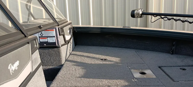 Slide: The Image of 2025 Ranger VX1788 WT boat interior with carpeted deck and mounted equipment. - 9