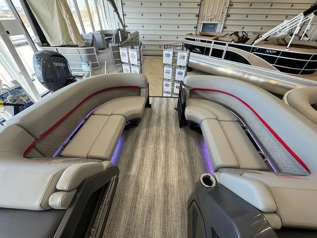 Slide: The Image of 2025 Bennington 22 MSB pontoon boat interior with plush seating and ambient lighting. - 10