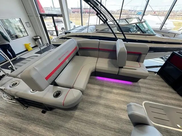 Slide: The Image of 2025 Bennington 22 MSB pontoon boat interior with gray seating and purple LED lighting. - 5