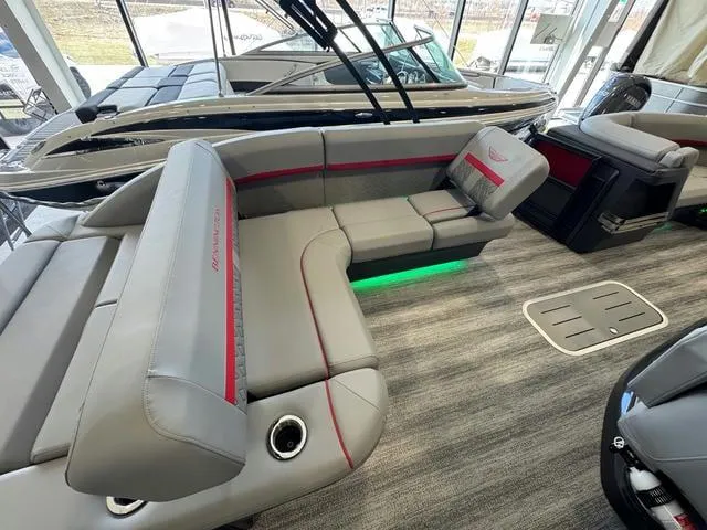 Slide: The Image of 2025 Bennington 22 MSB boat interior with gray seating and green LED lighting. - 8