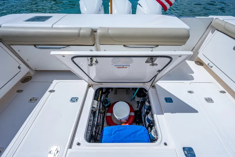 Slide: The Image of 2018 Pursuit OS 385 Offshore boat with open hatch revealing storage compartment. - 17