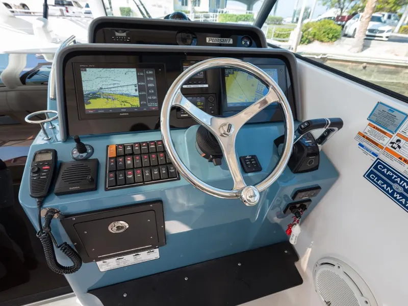 Slide: The Image of Helm of 2018 Pursuit OS 385 Offshore boat with navigation screens and controls. - 23
