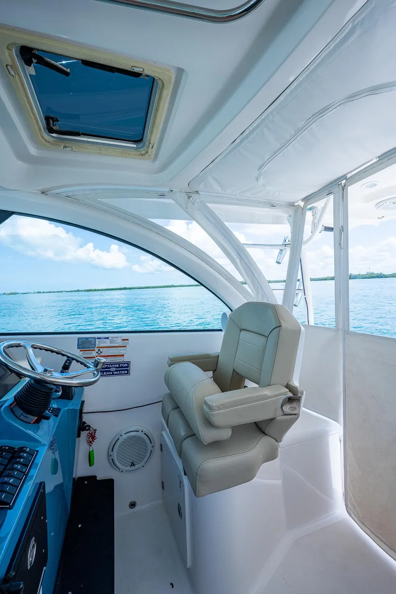 Slide: The Image of 2018 Pursuit OS 385 Offshore helm with luxurious seating and ocean view. - 25