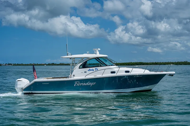 Slide: The Image of 2018 Pursuit OS 385 Offshore boat cruising on a sunny day with blue skies. - 3