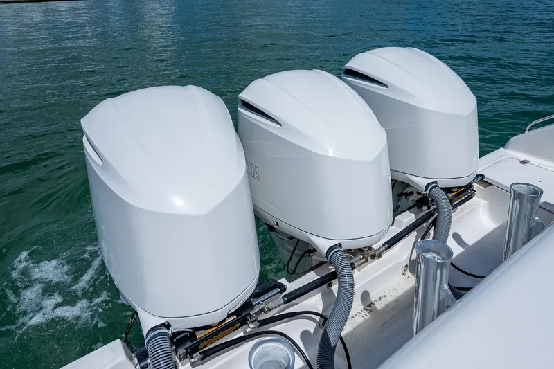 Slide: The Image of Triple outboard engines on a 2018 Pursuit OS 385 Offshore boat in water. - 43