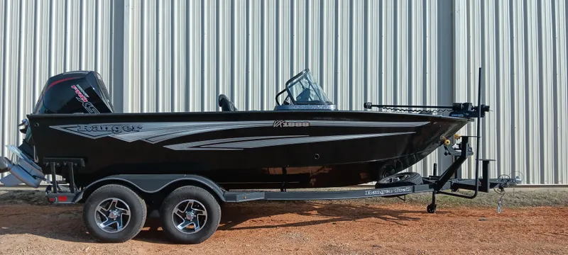 Slide: The Image of 2025 Ranger VX1888 WT boat, black exterior, on a trailer, parked outdoors. - 1