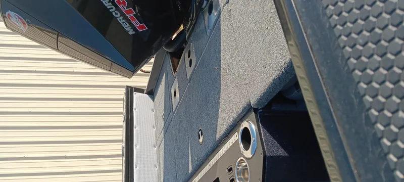 Slide: The Image of 2025 Ranger VX1888 WT boat interior with Mercury engine, featuring storage compartments and cup holders. - 15