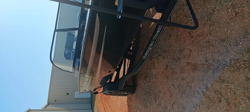 Slide: The Image of 2025 Ranger VX1888 WT boat on trailer, parked on gravel near a building. - 8