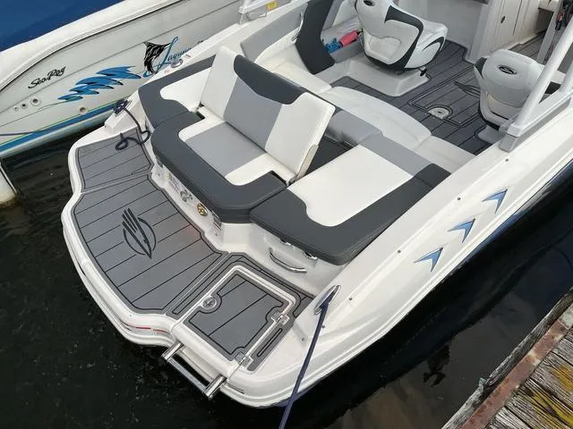 Slide: The Image of 2022 Chaparral 21 SSi boat with sleek seating and modern design at a dock. - 8