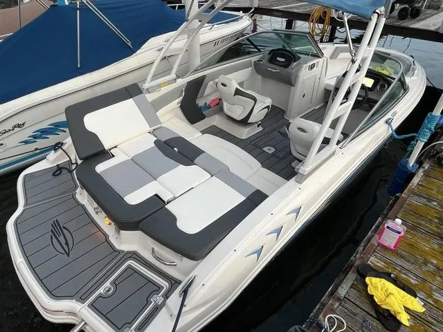 Slide: The Image of 2022 Chaparral 21 SSi boat with sleek seating and modern design at a dock. - 9