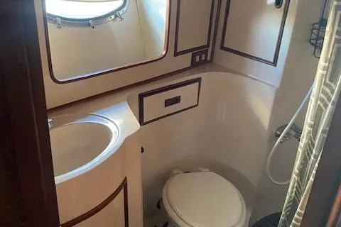 Slide: The Image of Compact bathroom in 1987 President 36 yacht with sink, toilet, and shower. - 10