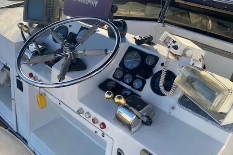 Slide: The Image of Helm of a 1987 President 36 boat with steering wheel and navigation instruments. - 3