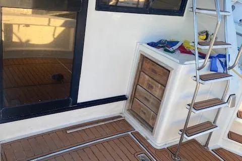 Slide: The Image of 1987 President 36 yacht deck with wooden flooring and metal ladder. - 4