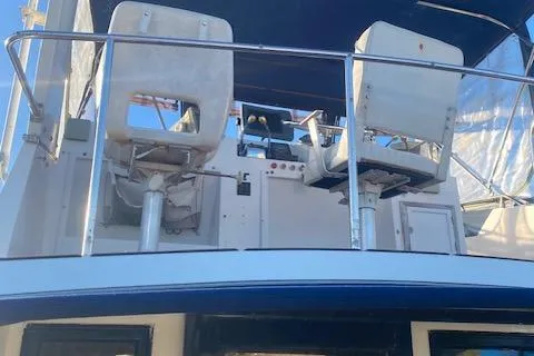 Slide: The Image of 1987 President 36 yacht helm with dual captain chairs and control panel. - 5