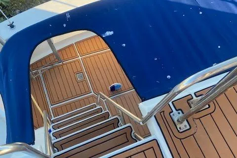 Slide: The Image of Staircase on 1987 President 36 yacht with teak flooring and blue canopy. - 6