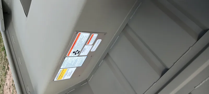 Slide: The Image of 2025 Tracker Grizzly 1436 Utility boat interior with safety labels visible. - 5