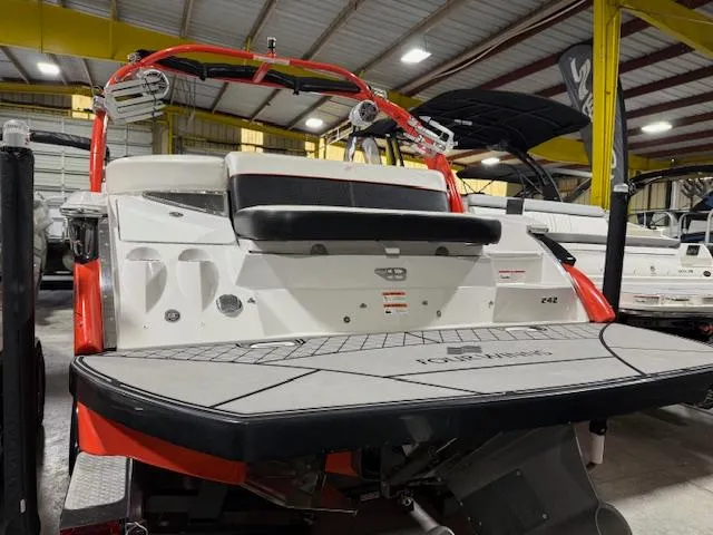 Slide: The Image of 2016 Four Winns TS242 boat in showroom, rear view with swim platform. - 10