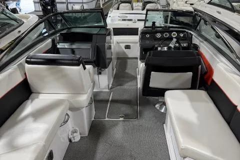 Slide: The Image of 2016 Four Winns TS242 boat interior with white and black seating, modern dashboard, and spacious layout. - 11
