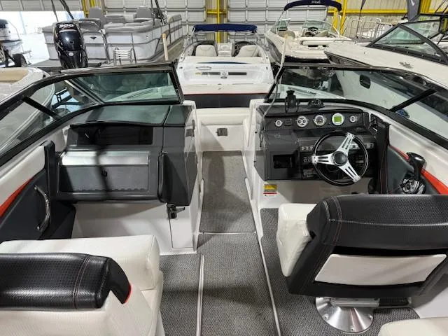 Slide: The Image of Interior view of 2016 Four Winns TS242 boat, featuring steering wheel and seating. - 4