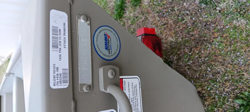 Slide: The Image of 2025 Tracker Grizzly 1436 Utility boat with identification labels and rear light. - 11