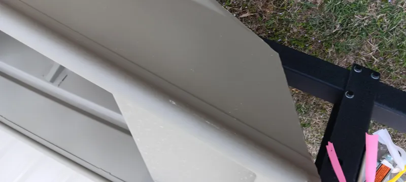 Slide: The Image of 2025 Tracker Grizzly 1436 Utility boat detail with metal and grass background. - 4