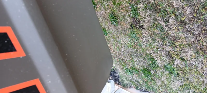 Slide: The Image of 2025 Tracker Grizzly 1436 Utility boat detail with grass background. - 9