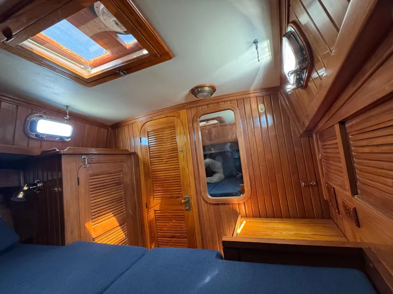 Slide: The Image of Interior of 1988 Cabo Rico 38XL sailboat with wooden paneling and skylight. - 13