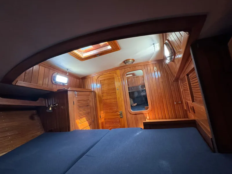 Slide: The Image of Interior cabin of 1988 Cabo Rico 38XL sailboat with wooden paneling and skylight. - 16