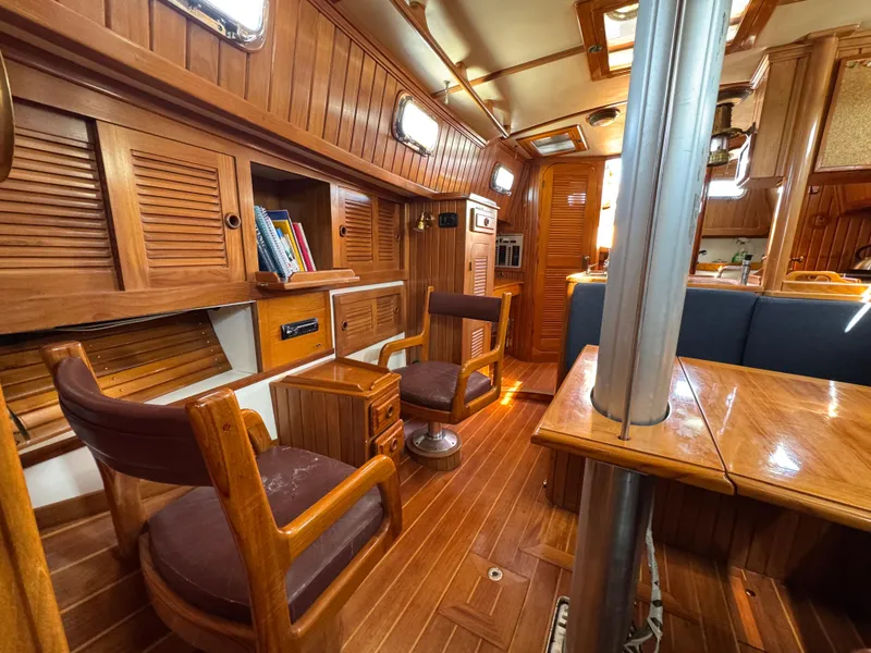Slide: The Image of Interior of 1988 Cabo Rico 38XL sailboat with wooden furnishings and cozy seating. - 23