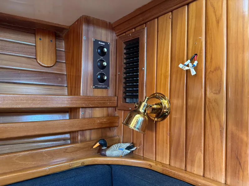 Slide: The Image of Interior of 1988 Cabo Rico 38XL yacht with wooden paneling and brass light fixture. - 24