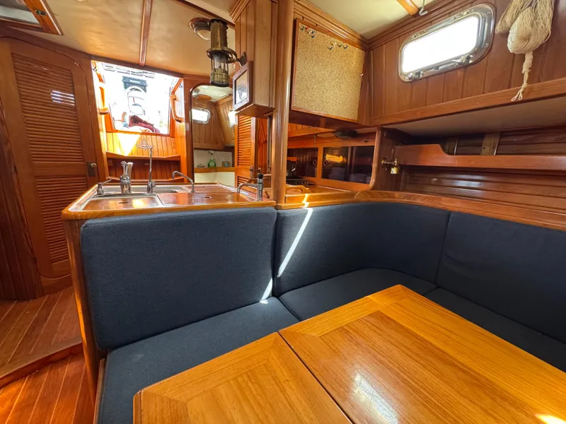 Slide: The Image of Interior of 1988 Cabo Rico 38XL sailboat with wooden finishes and cozy seating area. - 27